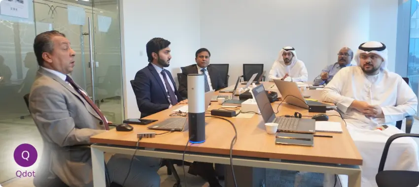 Business professionals in a meeting room discussing ISO consultancy and certification services in UAE